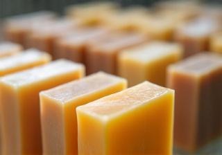Close-up of finished soap bars being inspected for quality and appearance